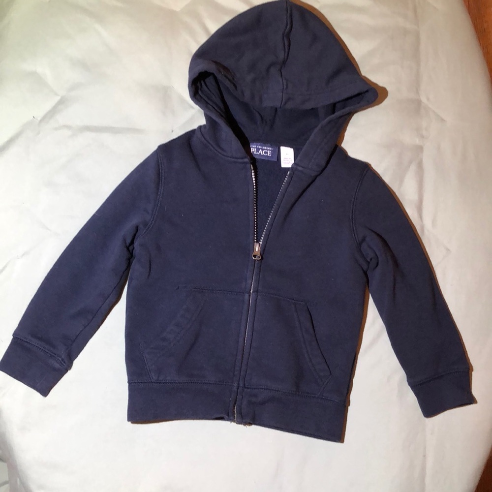 Navy blue child’s zipper sweatshirt.